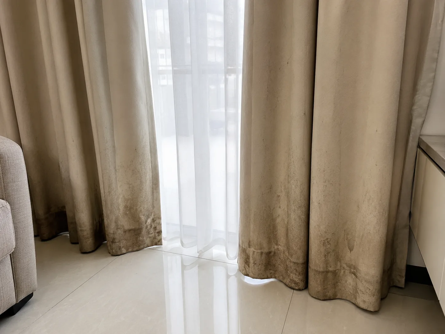 Close-up of stained curtain fabric before cleaning