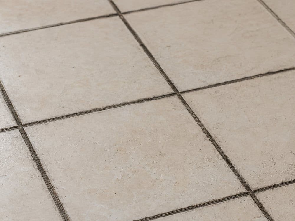 Grimy tile floor with blackened grout