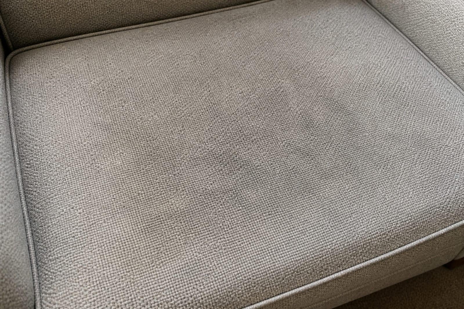 Fabric sofa — dulled by repeated guest use