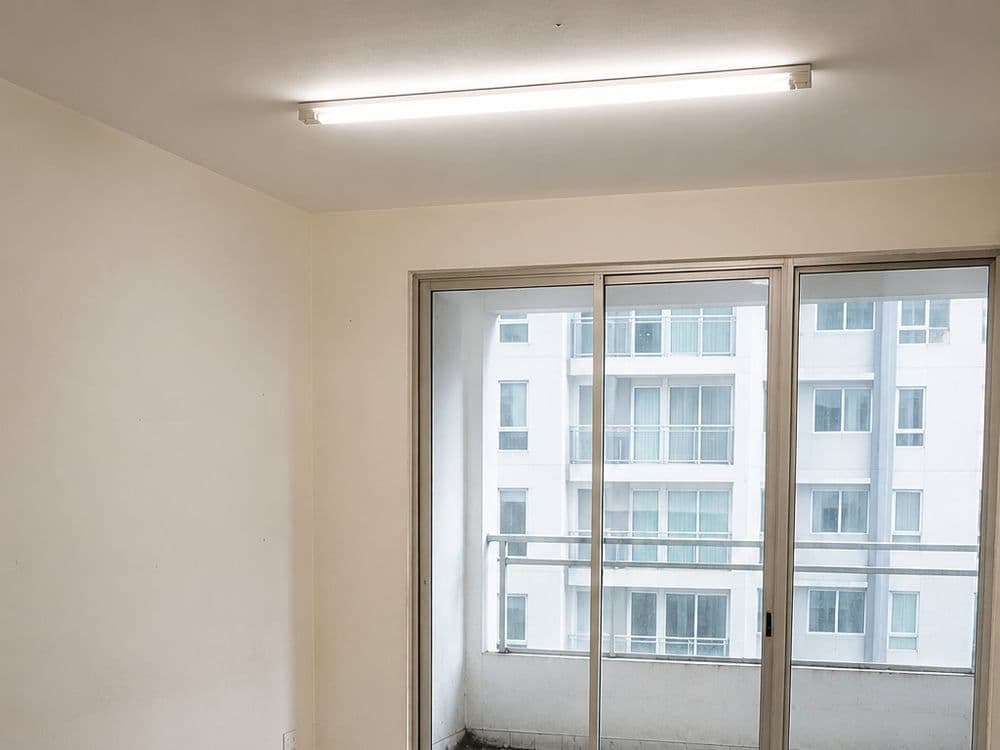 Empty room with dusty floor & window tracks