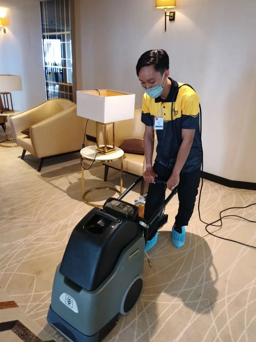 Our technician cleaning a hotel room carpet